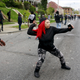 Demonstrators throw rocks at Baltimore police.